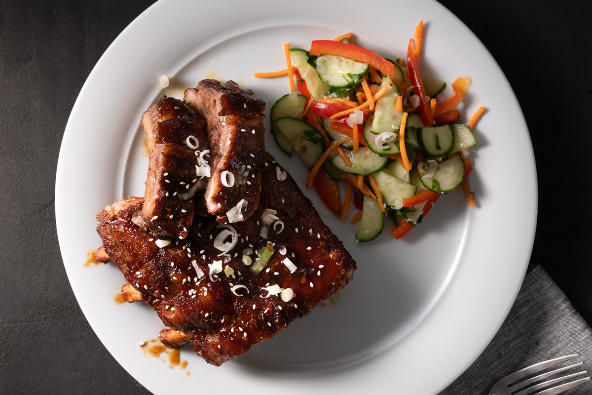 Five spice sweet chili BBQ ribs made with Prairie Fresh USA Prime®  St. Louis style spareribs served with a marinated cucumber salad.